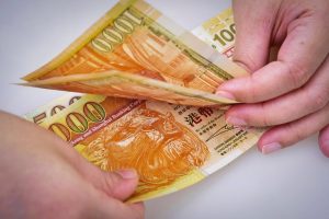 Хонконг продава щатски долари за борба с носенето на търговия, защита на валутата